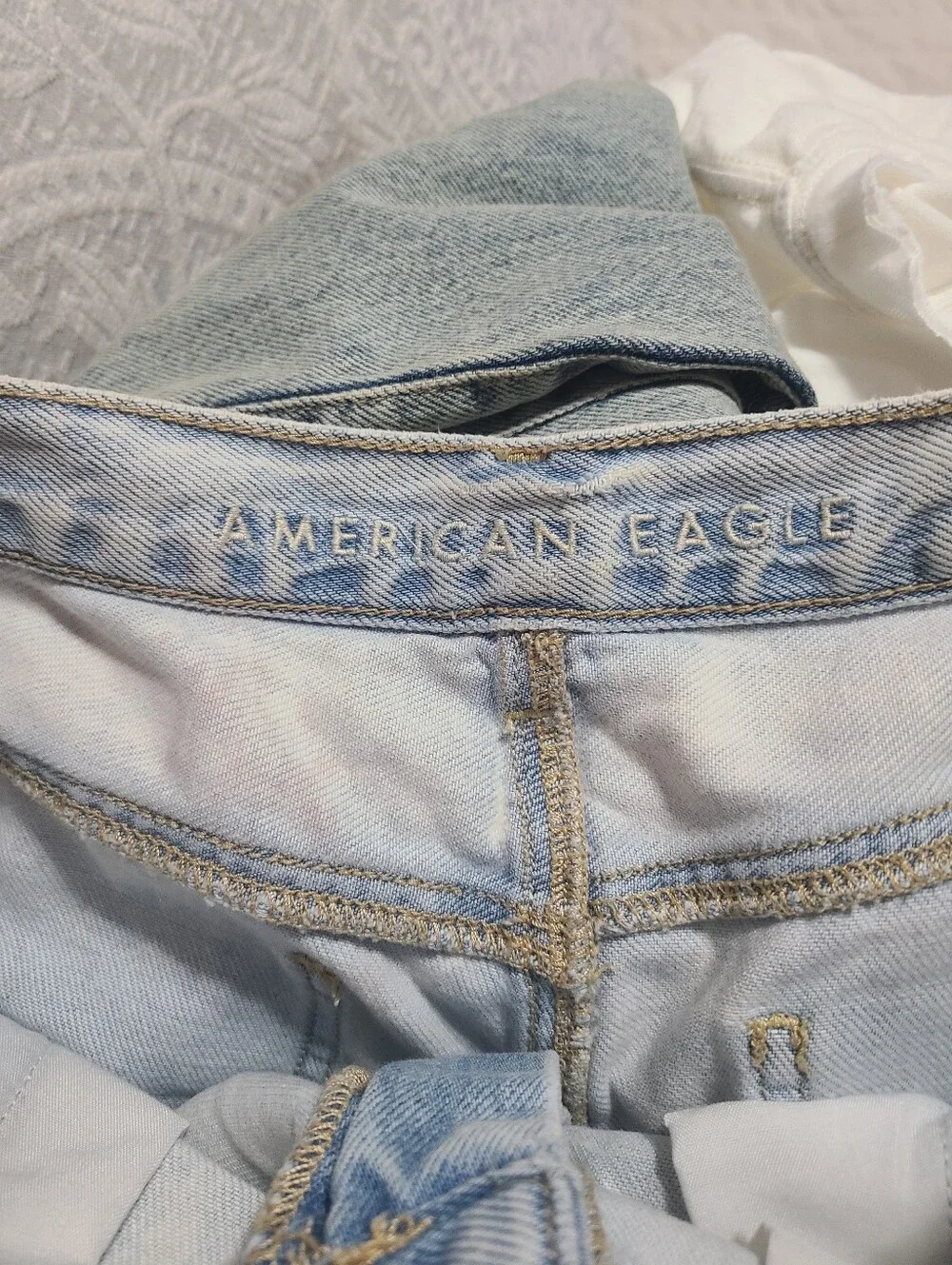 American Eagle Ripped Denim Baggy Mom Shorts in a light wash.